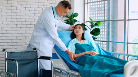 Doctor in professional uniform examining patient at hospital or medical clinic. Health care , medical and doctor staff service concept.の写真素材