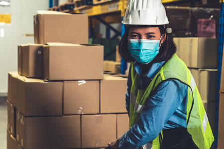 Factory industry worker working with face mask to prevent Covid-19 Coronavirus spreading during job...