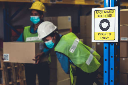Caution sign in factory warning to industry labor worker to prevent Covid-19 Coronavirus spreading during job business reopening period after epidemic crisis . Working safely concept .の写真素材