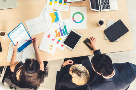 Business people group meeting shot from top view in office . Profession businesswomen, businessmen and office workers working in team conference with project planning document on meeting table .の写真素材