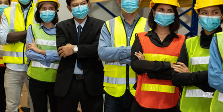 Group of factory industry worker working with face mask to prevent Covid-19 Coronavirus spreading...