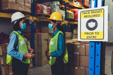 Caution sign in factory warning to industry labor worker to prevent Covid-19 Coronavirus spreading during job business reopening period after epidemic crisis . Working safely concept .の写真素材