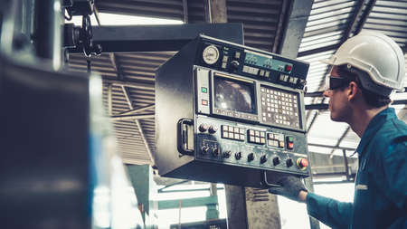 Smart factory worker using machine in factory workshop . Industry and engineering concept.の写真素材