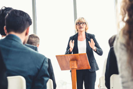 Group of business people meeting in a seminar conference . Audience listening to instructor in employee education training session . Office worker community summit forum with expert speaker .の写真素材