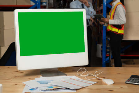 Computer with green screen display in warehouse storage room . Delivery and transportation software concept .の写真素材