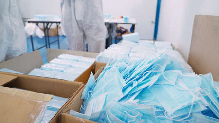 Face mask production line in modern factory . Concept of covid-19 coronavirus 2019 provention .の写真素材
