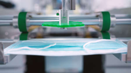 Face mask production line in modern factory . Concept of covid-19 coronavirus 2019 provention .の写真素材