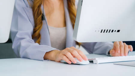 Business people wearing headset working in office to support remote customer or colleague. Call center, telemarketing, customer support agent provide service on telephone video conference call.の写真素材