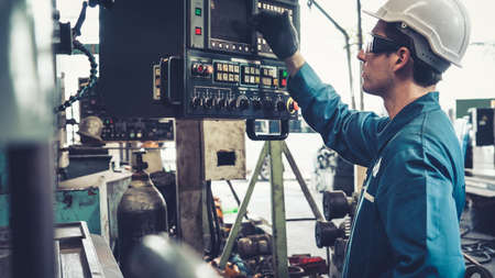 Smart factory worker using machine in factory workshop . Industry and engineering concept.の写真素材