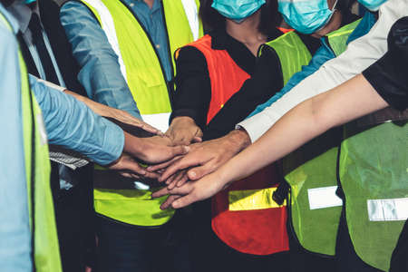Group of factory industry worker working with face mask to prevent Covid-19 Coronavirus spreading during job reopening period .の写真素材