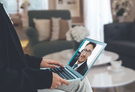 Video call business people meeting on virtual workplace or remote office. Telework conference call using smart video technology to communicate colleague in professional corporate business.の写真素材