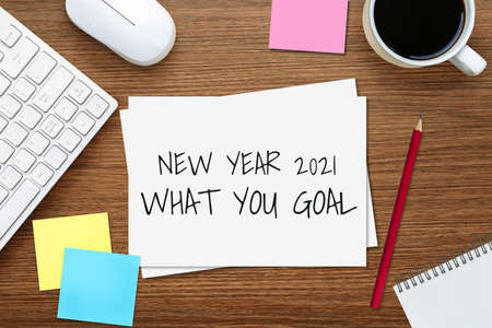 2021 Happy New Year Resolution Goal List - Business office desk with notebook written in handwriting about plan listing of new year goals and resolutions setting. Change and determination concept.の写真素材