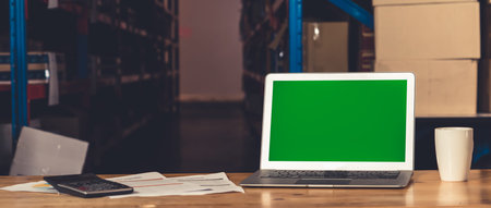 Computer with green screen display in warehouse storage room . Delivery and transportation software...