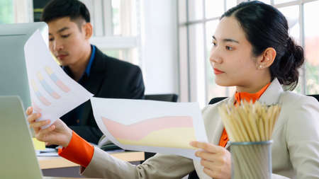 Business people working at table in modern office room while analyzing financial data report .の写真素材
