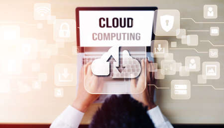 Cloud computing technology and online data storage for global data sharing. Computer connects to internet network server service for cloud data transfer presented in 3D futuristic graphic interface.の写真素材