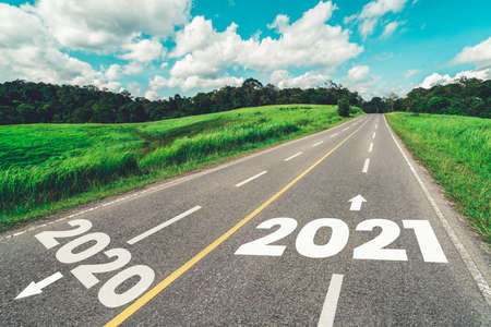 2021 New Year road trip travel and future vision concept . Nature landscape with highway road leading forward to happy new year celebration in the beginning of 2021 for fresh and successful start .の写真素材