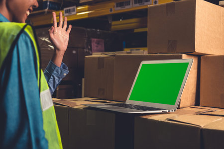 Computer with green screen display in warehouse storage room . Delivery and transportation software...