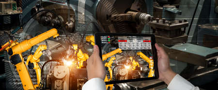 Engineer controls robotic arms by augmented reality industry technology application software. Smart...