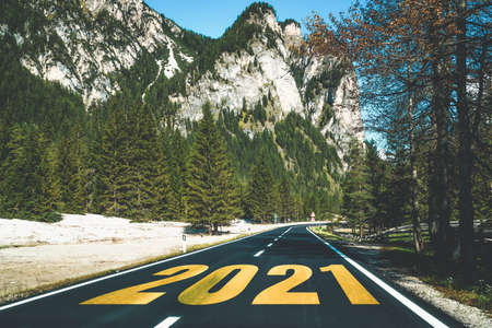 2021 New Year road trip travel and future vision concept . Nature landscape with highway road leading forward to happy new year celebration in the beginning of 2021 for fresh and successful start .の写真素材