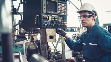 Smart factory worker using machine in factory workshop . Industry and engineering concept.の写真素材