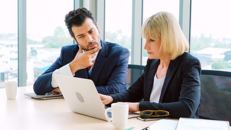 Two business people talk project strategy at office meeting room. Businessman discuss project...