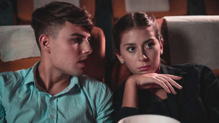 Men and women are watching mysterious movies and talking about the stories that happened in the movies.の写真素材