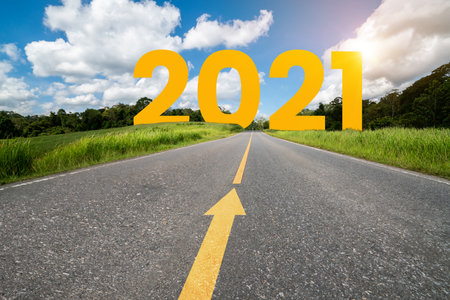 2021 New Year road trip travel and future vision concept . Nature landscape with highway road leading forward to happy new year celebration in the beginning of 2021 for fresh and successful start .の写真素材