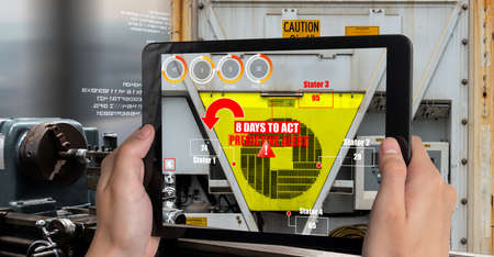 Engineer use augmented reality software in smart factory production line with automated application . Futuristic machinery in working in concept of Industry 4.0 or 4th industrial revolution.の写真素材