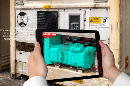 Engineer use augmented reality software in smart factory production line with automated application . Futuristic machinery in working in concept of Industry 4.0 or 4th industrial revolution.の写真素材