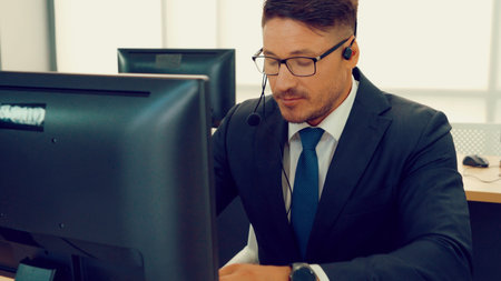 Business people wearing headset working in office to support remote customer or colleague. Call...