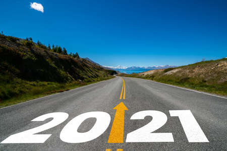 2021 New Year road trip travel and future vision concept . Nature landscape with highway road leading forward to happy new year celebration in the beginning of 2021 for fresh and successful start .の写真素材