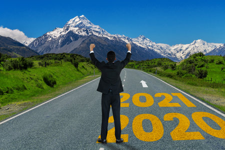 The 2021 New Year journey and future vision concept . Businessman traveling on highway road leading...