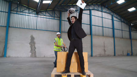 Funny factory workers dance in the factory . Happy people at work .の写真素材