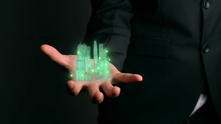 Businessman holds 3D city model showing augmented reality technology . Futuristic urban hologram...