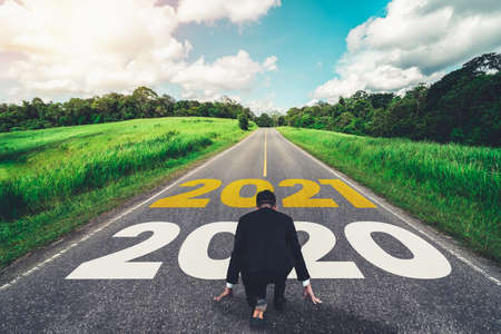 The 2021 New Year journey and future vision concept . Businessman traveling on highway road leading forward to happy new year celebration in beginning of 2021 for fresh and successful start .の写真素材