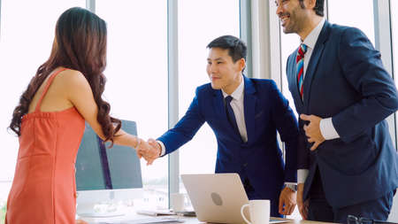 Job seeker and manager handshake in job interview meeting at corporate office. The young interviewee seeking for a professional career job opportunity . Human resources and recruitment concept.の写真素材