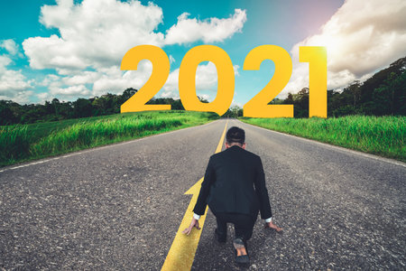 The 2021 New Year journey and future vision concept . Businessman traveling on highway road leading forward to happy new year celebration in beginning of 2021 for fresh and successful start .の写真素材