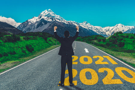 The 2021 New Year journey and future vision concept . Businessman traveling on highway road leading...