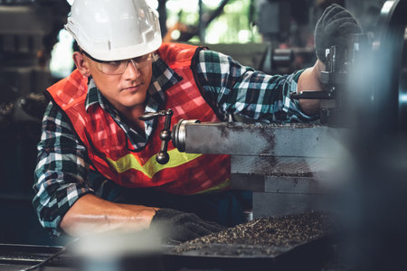 Smart factory worker or engineer do machine job in a manufacturing workshop . Industry and...