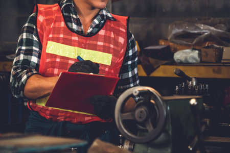 Smart factory worker or engineer do machine job in a manufacturing workshop . Industry and...
