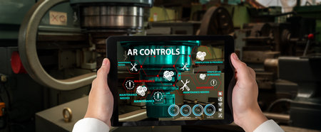 Engineer use augmented reality software in smart factory production line with automated application . Futuristic machinery in working in concept of Industry 4.0 or 4th industrial revolution.の写真素材
