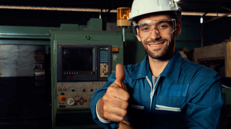 Young skillful factory worker or engineer close up portrait in factory . Industry and engineering concept .の写真素材