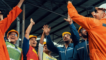 Skillful worker celebrate success in the factory . Industrial people and manufacturing labor concept...
