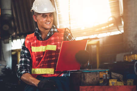 Manufacturing worker working with clipboard to do job procedure checklist . Factory production line occupation quality control concept .の写真素材