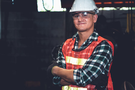 Young factory job worker or engineer close up portrait in manufacturing factory . Industry and...