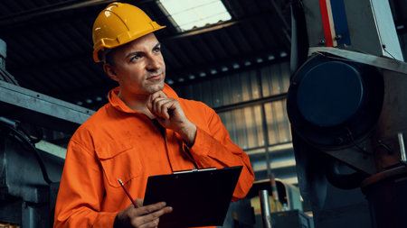 Skillful factory worker working with clipboard to do job procedure checklist . Factory production...