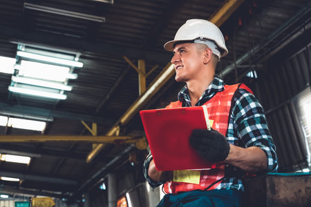 Manufacturing worker working with clipboard to do job procedure checklist . Factory production line...