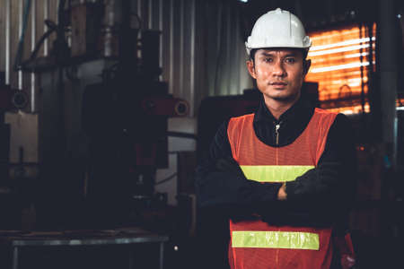 Young factory job worker or engineer close up portrait in manufacturing factory . Industry and engineering concept .の写真素材