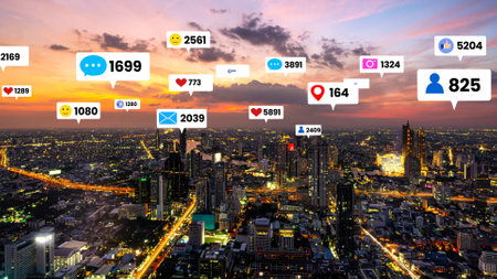 Social media icons fly over city downtown showing people engagement connection through social network application platform . Concept for online community and social media marketing strategy .の写真素材