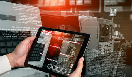 Engineer use augmented reality software in smart factory production line with automated application . Futuristic machinery in working in concept of Industry 4.0 or 4th industrial revolution.の写真素材